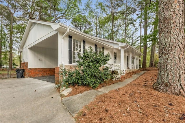 2694 Hickory Valley Dr, Snellville, GA 30078 - view of front of property featuring concrete driveway, covered porch, a carport, and stone siding