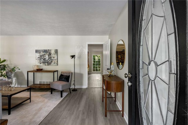 2694 Hickory Valley Dr, Snellville, GA 30078 - foyer entrance featuring wood finished floors and a textured ceiling