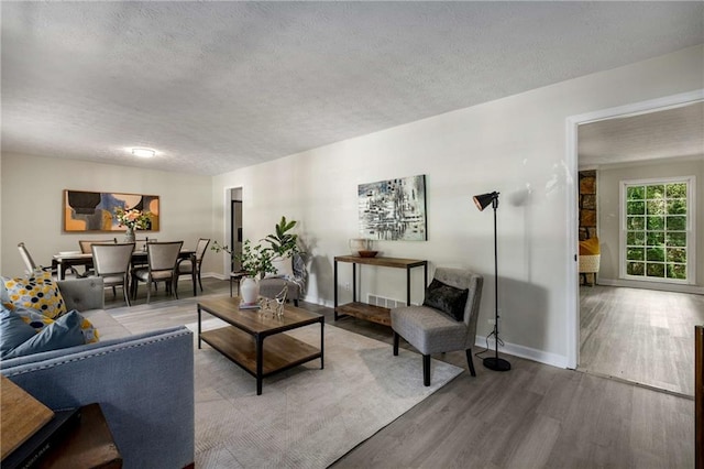 2694 Hickory Valley Dr, Snellville, GA 30078 - living room featuring wood finished floors and a textured ceiling
