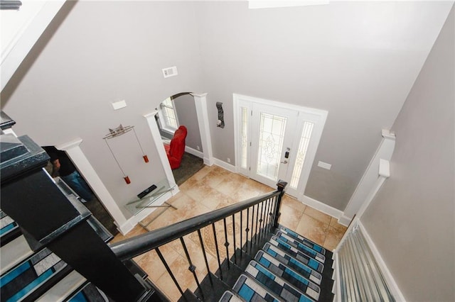 1120 Carl Bethlehem Rd, Winder, GA 30680 - stairway with a towering ceiling, arched walkways, and tile patterned floors