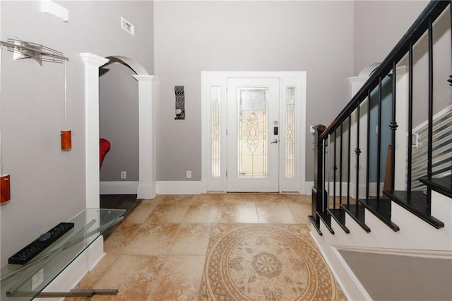 1120 Carl Bethlehem Rd, Winder, GA 30680 - foyer entrance featuring ornate columns, a high ceiling, stairway, and arched walkways