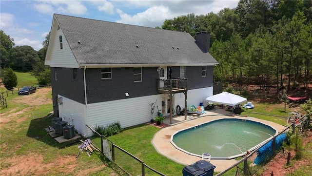 1120 Carl Bethlehem Rd, Winder, GA 30680 - back of house with a chimney, a balcony, brick siding, and a patio area