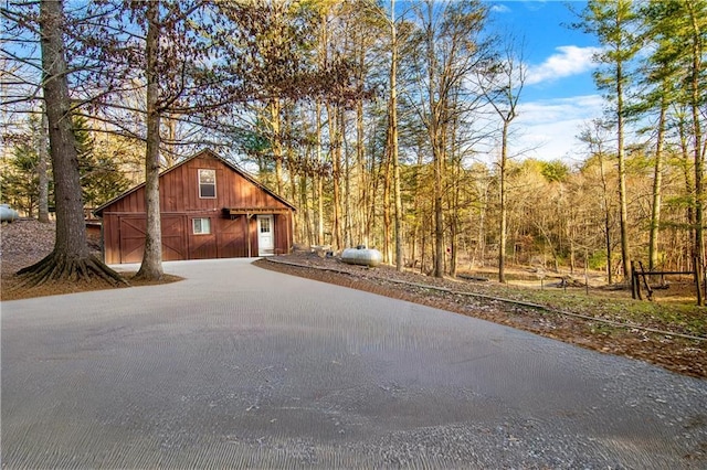 exterior space with a garage, a barn, and an outbuilding