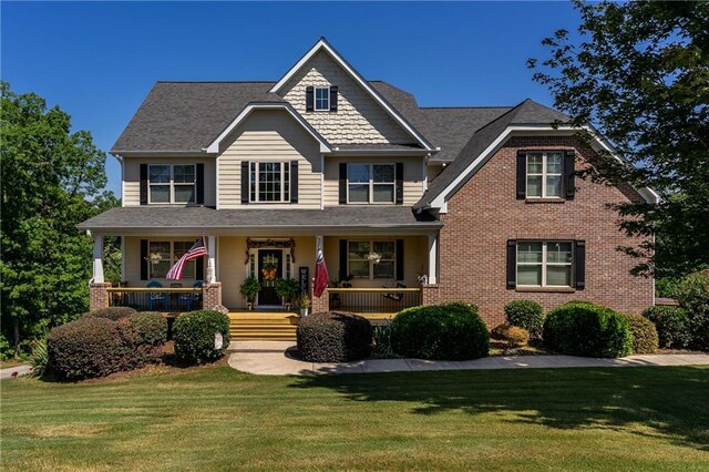 view of front of house featuring a porch and a front lawn