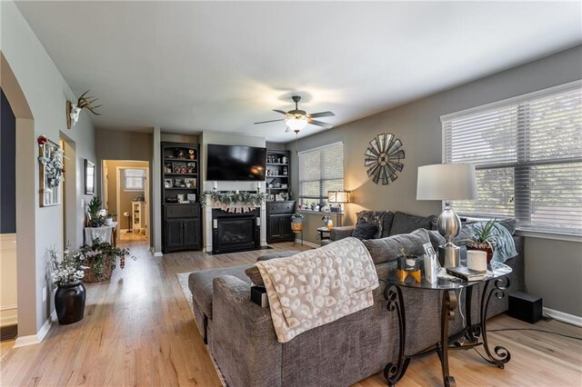 living room featuring ceiling fan and light wood-type flooring