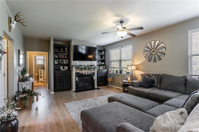 living room featuring ceiling fan and light hardwood / wood-style floors