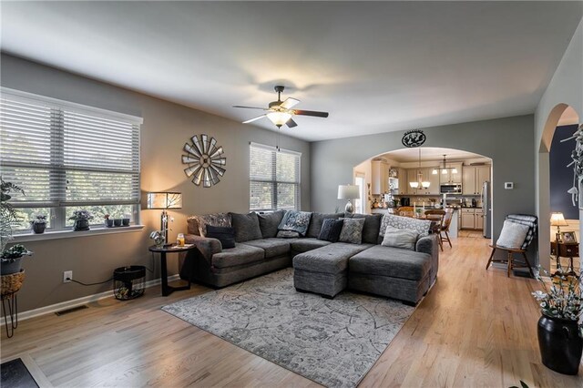 living room featuring ceiling fan and light hardwood / wood-style floors