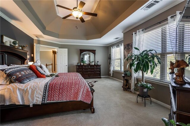 bedroom with ornamental molding, a raised ceiling, and light carpet