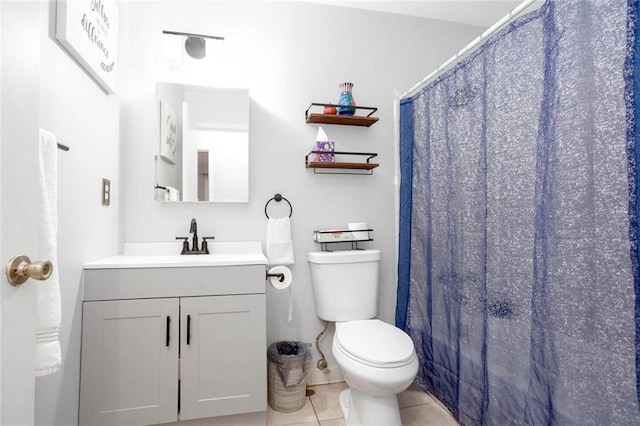 full bathroom featuring vanity, tile patterned flooring, and toilet