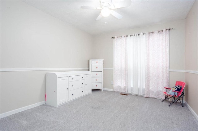 unfurnished bedroom featuring light colored carpet, baseboards, and ceiling fan