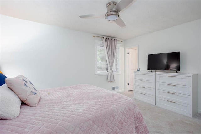 bedroom featuring light carpet, ceiling fan, and baseboards