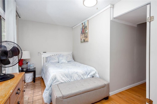 bedroom featuring baseboards and light wood-style flooring