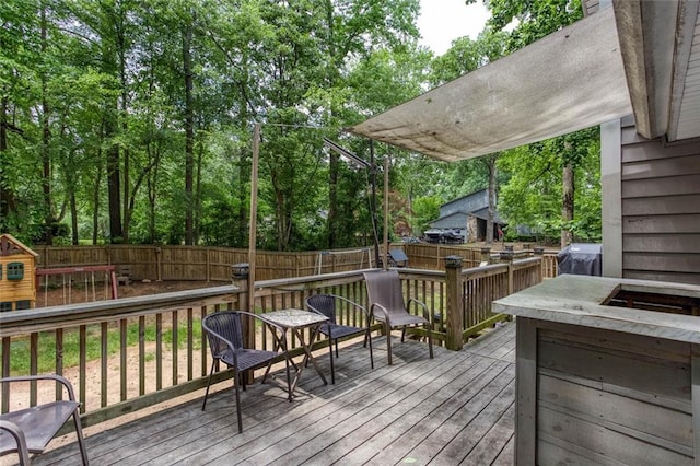 wooden deck featuring a fenced backyard and grilling area