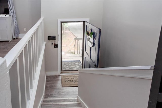 stairway featuring wood finished floors and baseboards