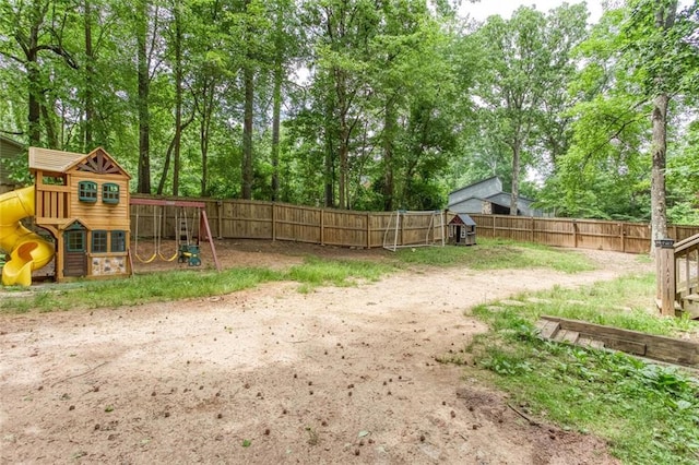 fenced backyard with a playground and view of scattered trees