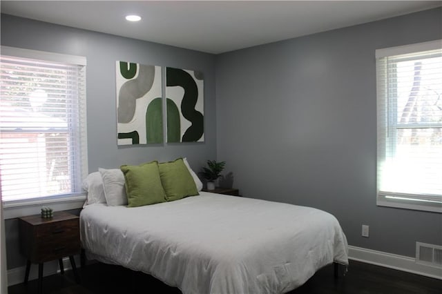 bedroom with dark wood-type flooring