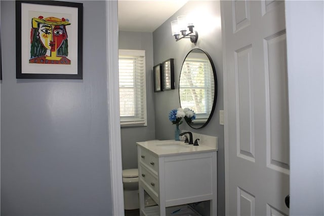 bathroom featuring toilet and vanity