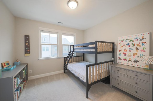 bedroom with baseboards, visible vents, and light colored carpet