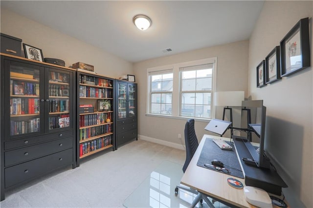 home office with carpet, visible vents, and baseboards