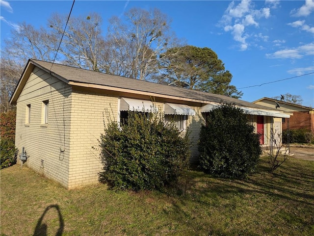 view of home's exterior with a lawn