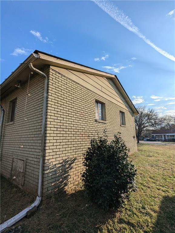 view of home's exterior with a yard