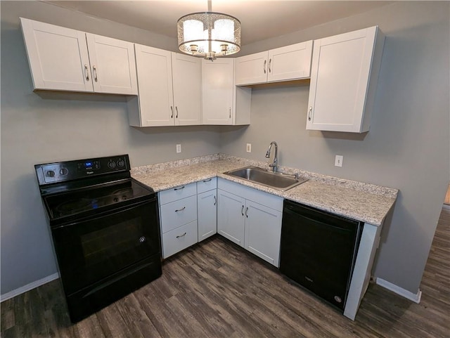 kitchen featuring sink, white cabinets, hanging light fixtures, black appliances, and dark wood-type flooring