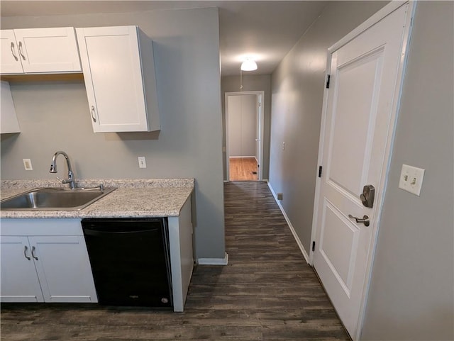 kitchen featuring dark hardwood / wood-style flooring, dishwasher, sink, and white cabinets