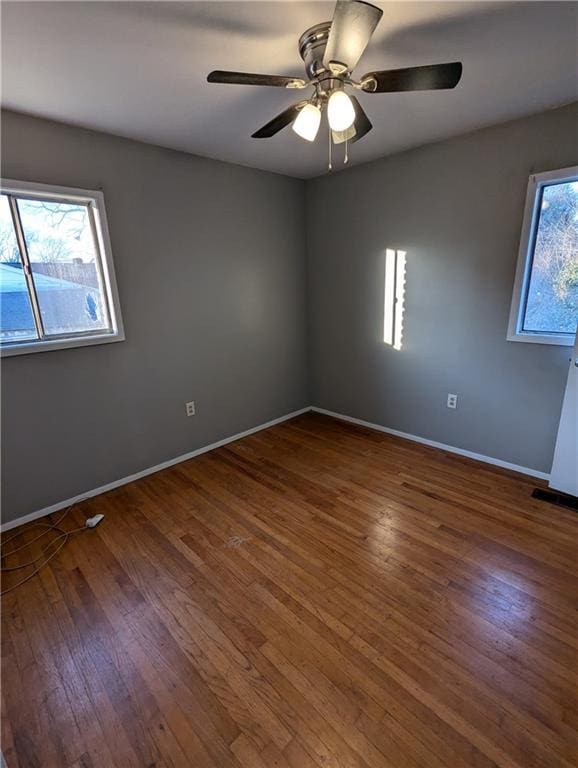 empty room featuring dark hardwood / wood-style floors and ceiling fan