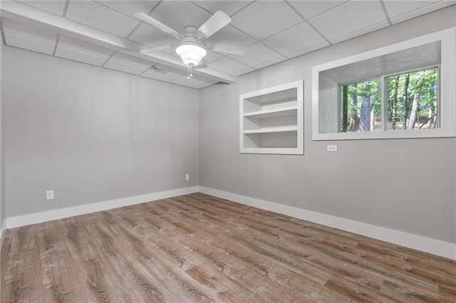 7875 Robin Rd, Cumming, GA 30041 - spare room with built in features, ceiling fan, wood finished floors, baseboards, and a paneled ceiling