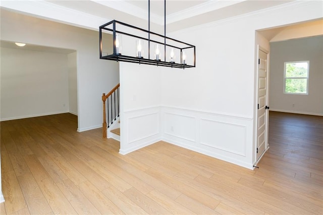 296 River Run Dr, Dallas, GA 30132 - unfurnished dining area featuring stairway, light wood-style floors, a chandelier, ornamental molding, and wainscoting