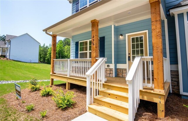 296 River Run Dr, Dallas, GA 30132 - view of exterior entry featuring a porch and a lawn