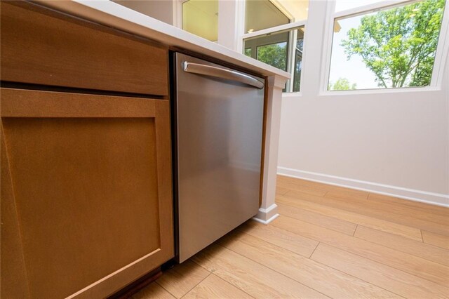 296 River Run Dr, Dallas, GA 30132 - kitchen view of stainless steel dishwasher, light wood-style flooring, and baseboards