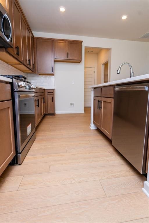 296 River Run Dr, Dallas, GA 30132 - kitchen with stainless steel appliances, light wood-style flooring, recessed lighting, baseboards, and backsplash