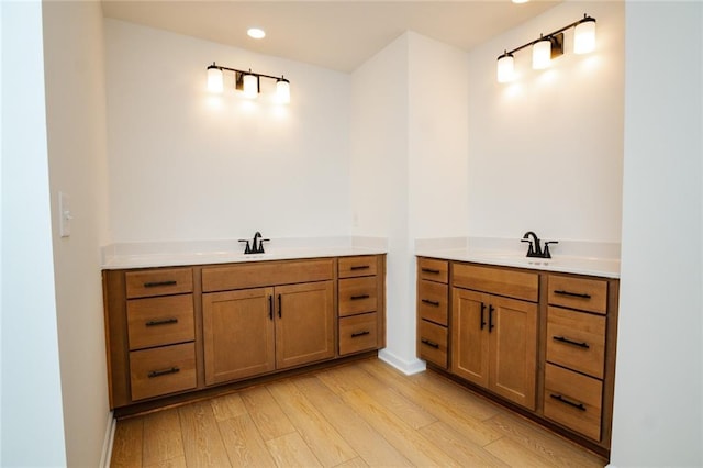 296 River Run Dr, Dallas, GA 30132 - full bathroom with two vanities, wood finished floors, baseboards, and recessed lighting