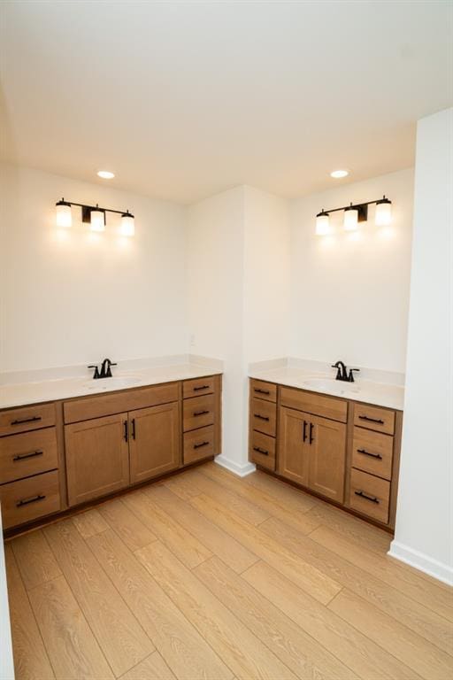 296 River Run Dr, Dallas, GA 30132 - bathroom with two vanities, wood finished floors, recessed lighting, and baseboards