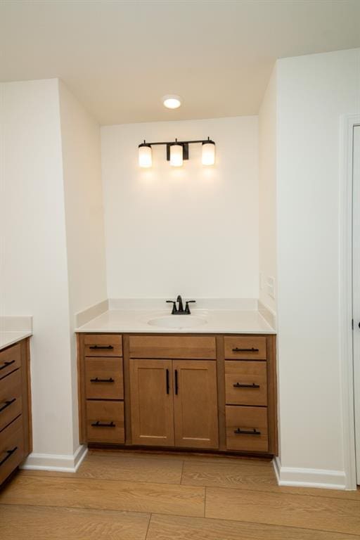 296 River Run Dr, Dallas, GA 30132 - bathroom with vanity, wood finished floors, baseboards, and recessed lighting
