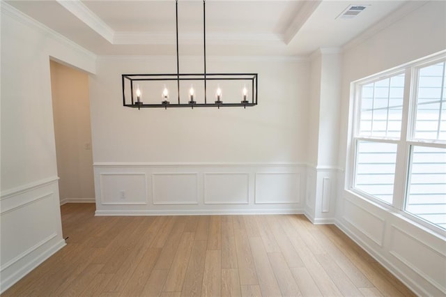 296 River Run Dr, Dallas, GA 30132 - unfurnished dining area featuring light wood-style flooring, a chandelier, a tray ceiling, ornamental molding, and a decorative wall