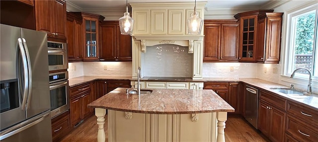 kitchen with light stone counters, appliances with stainless steel finishes, and a sink