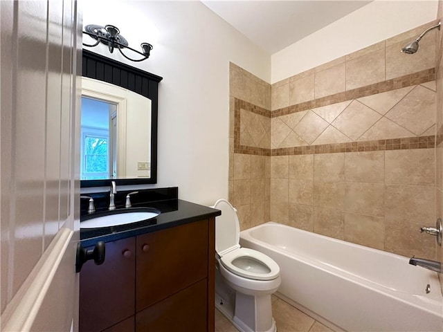 bathroom with tile patterned flooring, toilet, vanity, and washtub / shower combination