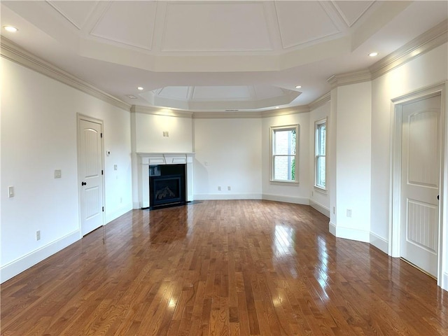 unfurnished living room with baseboards, a fireplace with flush hearth, hardwood / wood-style floors, and crown molding