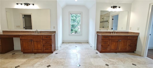 bathroom with a sink, two vanities, and a stall shower