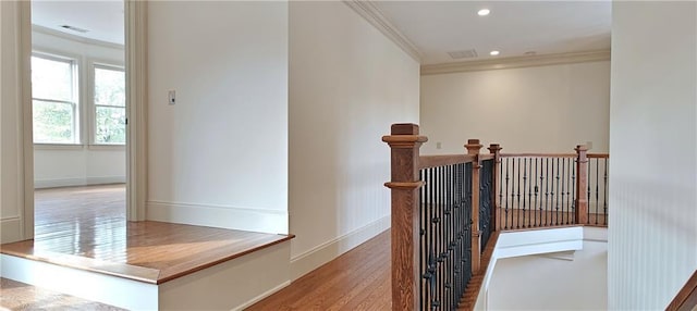 stairway with wood finished floors, visible vents, baseboards, recessed lighting, and crown molding