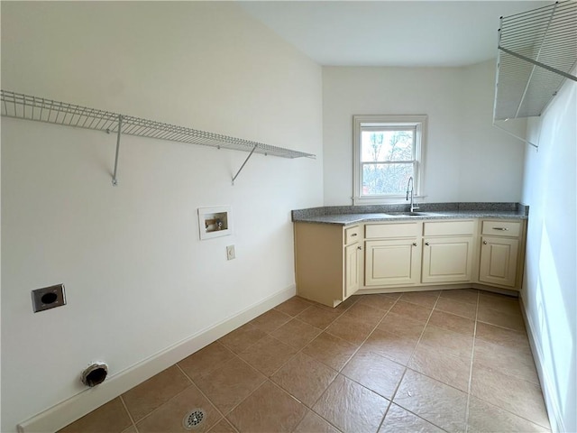 washroom with hookup for a washing machine, baseboards, hookup for an electric dryer, light tile patterned flooring, and a sink