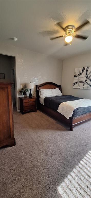 bedroom with ceiling fan and carpet floors