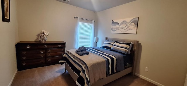 bedroom with dark colored carpet