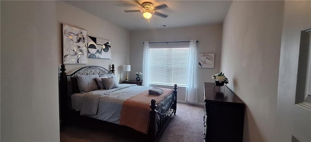 bedroom with ceiling fan and dark carpet