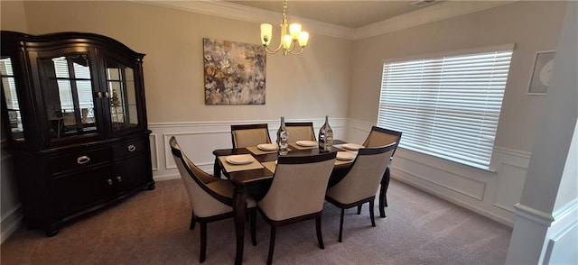 dining area with an inviting chandelier, ornamental molding, and carpet floors