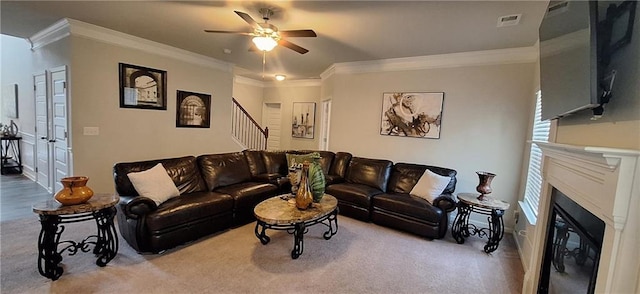 living room featuring ornamental molding, light colored carpet, and ceiling fan