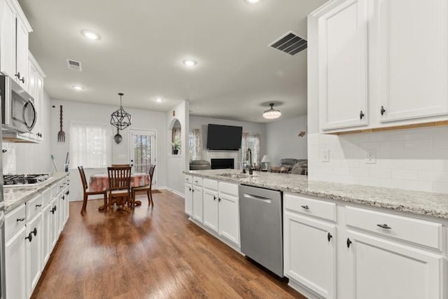 kitchen featuring light stone countertops, appliances with stainless steel finishes, sink, and white cabinets