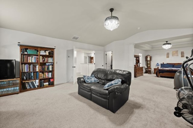 carpeted living room with lofted ceiling, a chandelier, and a tray ceiling